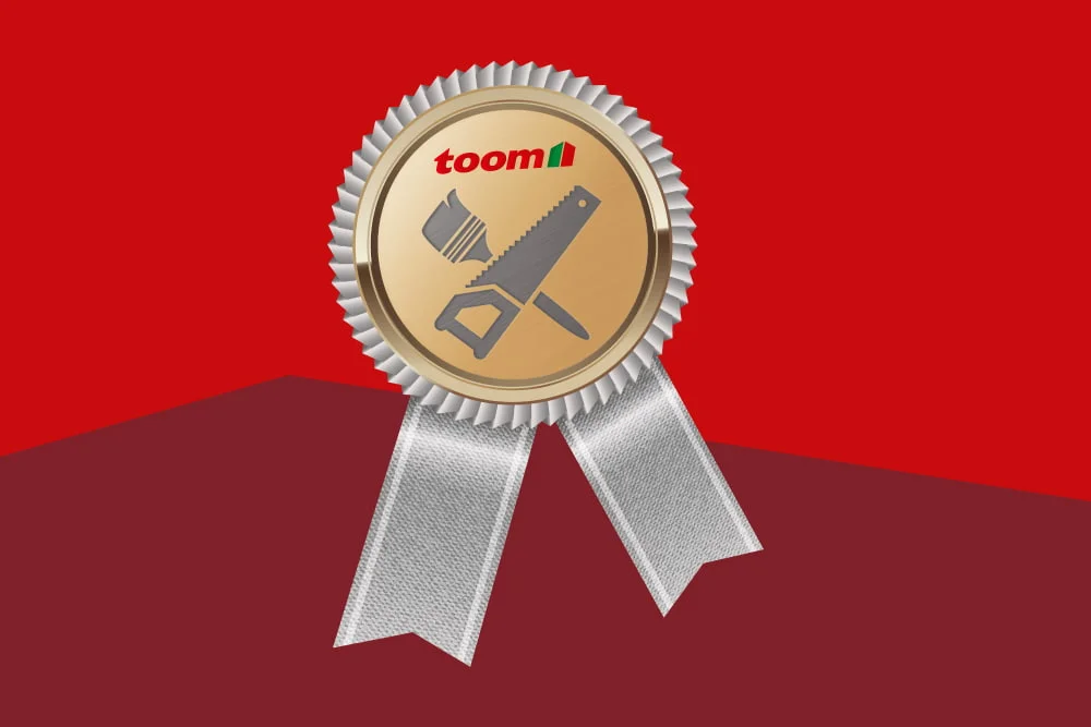 Goldene Medaille mit Werkzeug-Symbolen auf rotem Hintergrund.